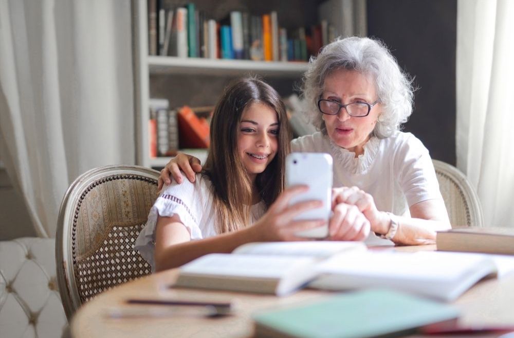 grandmother and grandchild looking at phone